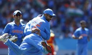 Auckland: Indian cricketers celebrate fall of a wicket during an ICC World Cup 2015 match between India and Zimbabwe at the Eden Park in Auckland, New Zealand on March 14, 2015. (Photo: IANS)