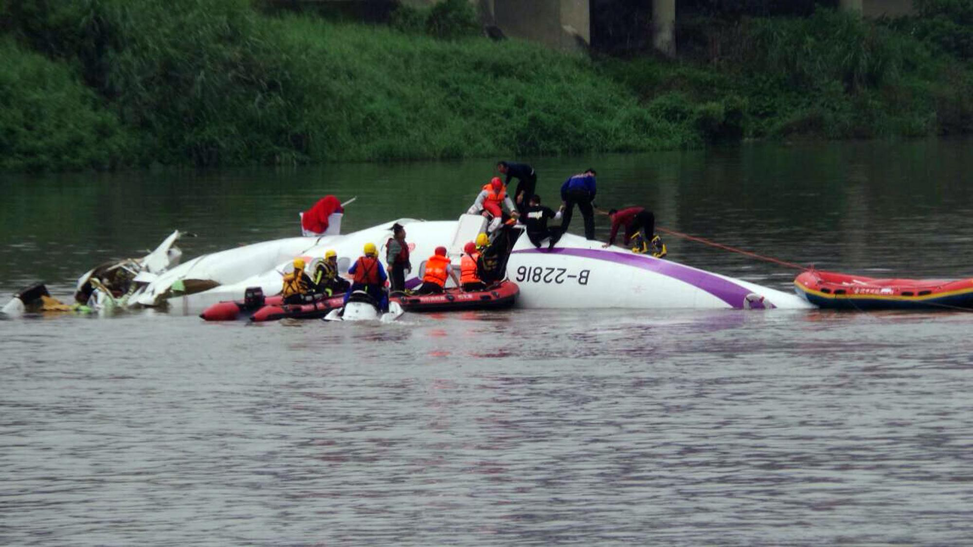 Rescuers work at the site of the plane accident in Taipei. Image Source: Xinhua/IANS