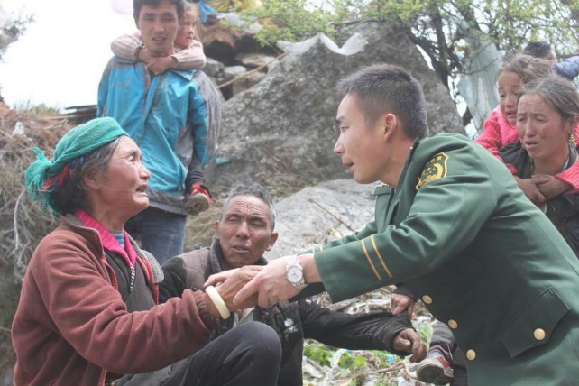 A soldier consoles an aged woman in Gyirong County in Shigatse (Xigaze), southwest China's Tibet Autonomous Region in Nepal. (Image Source: IANS)