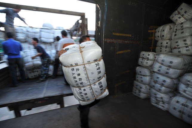 People transport relief materials to a train in Wuhan, capital of central China's Hubei Province. (Image source: IANS)