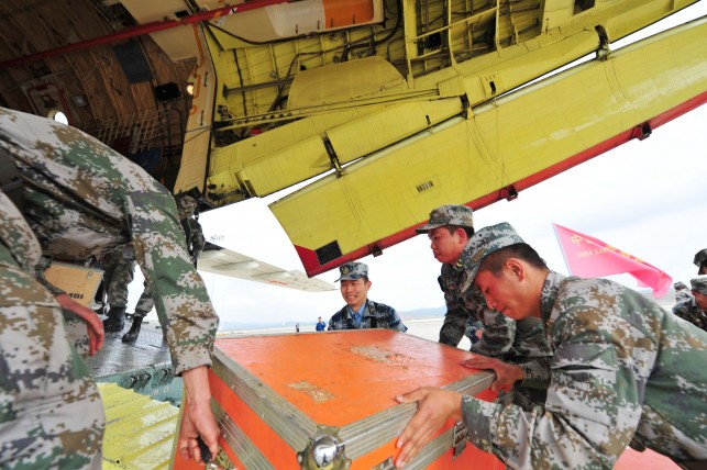 Officers and soldiers load rescue materials on an  IL-76 aircraft at an airport before departing for earthquake-stricken Nepal in Kunming, capital of southwest China's Yunnan Province. (Image source: IANS)
