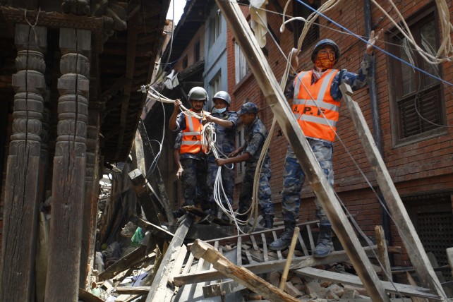 Members of the Nepalese Armed Police Force try to rescue people stuck in houses in Bhaktapur, Nepal. (Image source: IANS)
