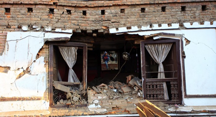 A rescuer is reflected in the mirror of a room of a damaged building after the massive earthquake in Kathmandu, Nepal. (Image source: IANS)