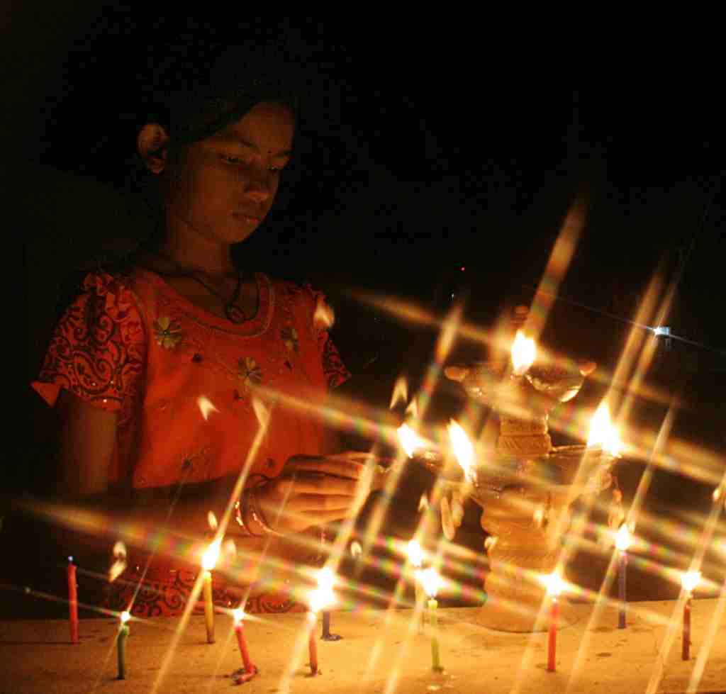 A girl lighting candles in Cuttack