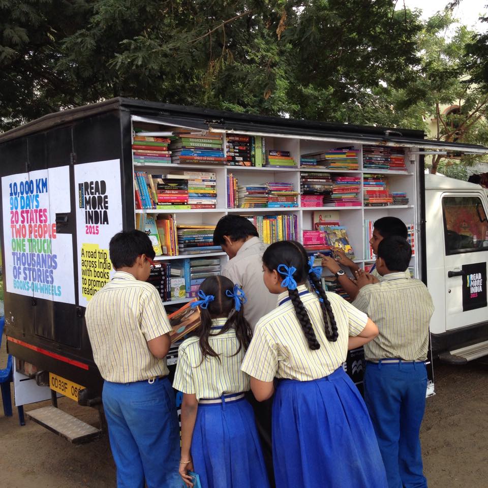 Schoolchildren go through books at the Walking BookFairs truck